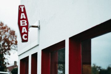 a red and white signage mounted on wall