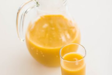 pitcher and drinking glass filled with juice