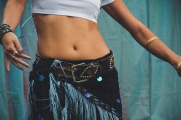 person wearing white cropped top and black bottoms