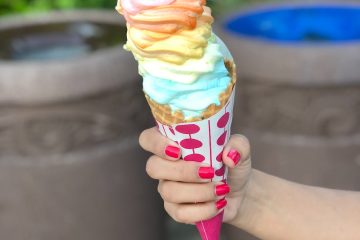 selective focus photography of person holding ice cream