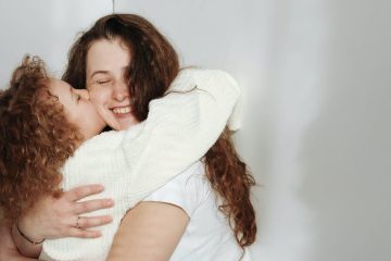child hugging and kissing mother