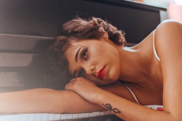 woman leaning on piano