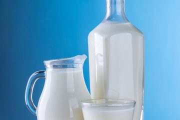 close up of milk against blue background