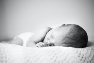 grayscale photo of baby sleeping