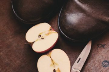 sliced apple beside brown handled knife