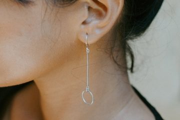 woman wearing silver colored earring