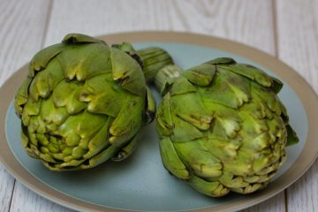 green artichoke on gray round plate