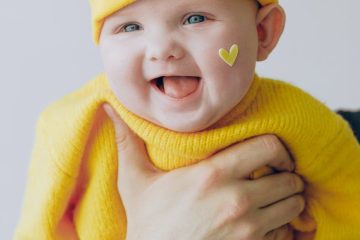 baby in yellow knit cap and yellow knit sweater