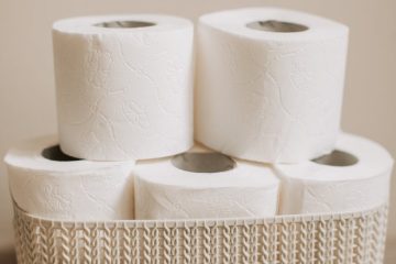 stack of toilet paper rolls in a basket