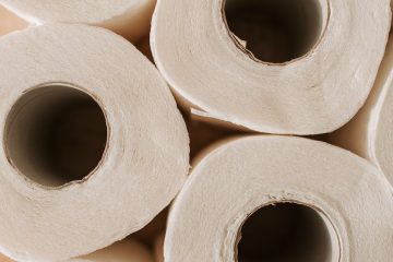 set of toilet paper on wooden background