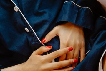 close up photo of woman touching her abdomen