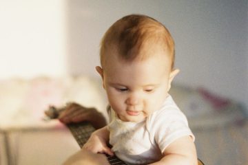 baby boy holding a guitar