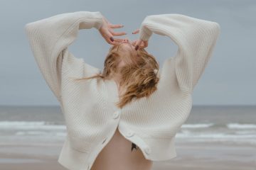 unrecognizable sensual woman with naked belly on sea beach