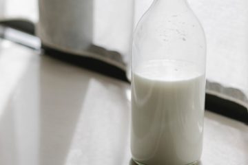 glass bottle with milk on table