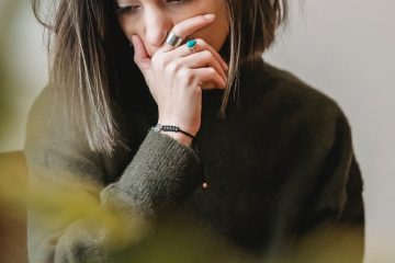 lady crying with hand on mouth in room