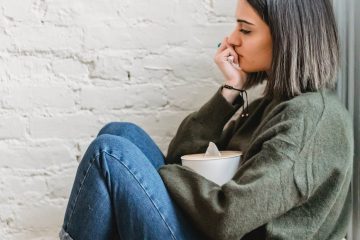 sad woman with tissue box crying on couch