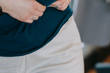 overweight woman touching belly with hands