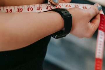 plus size woman measuring belly