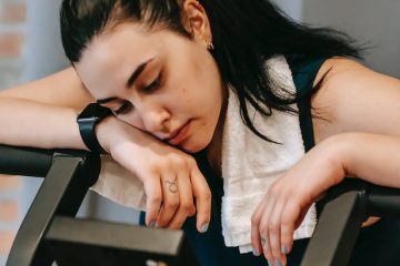 exhausted young woman on exercise machine