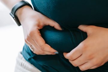 obese woman holding fold on waist
