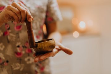 woman using little gongs for relaxation