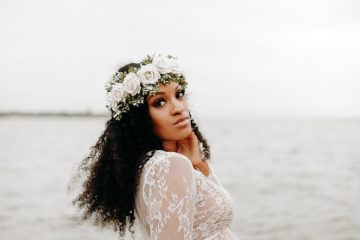 gentle pregnant black woman in lace dress on shore