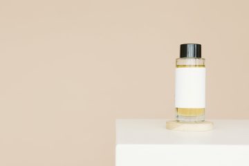 white and gold bottle on white table