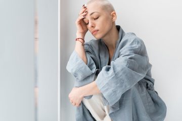 unhappy patient with headache and closed eyes