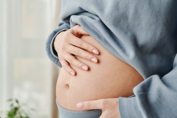 pregnant woman touching her belly